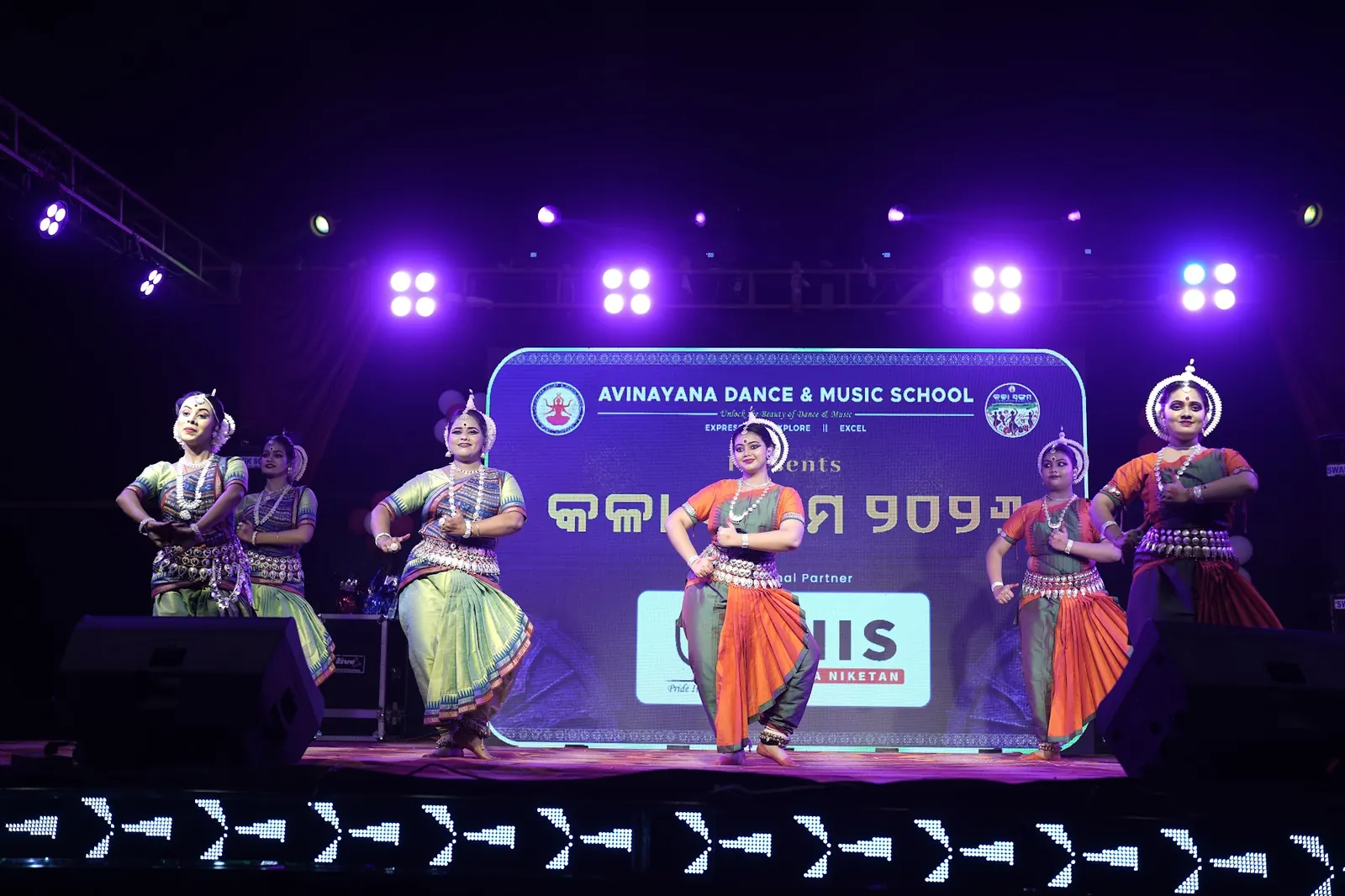 Avinayana students performing together on stage